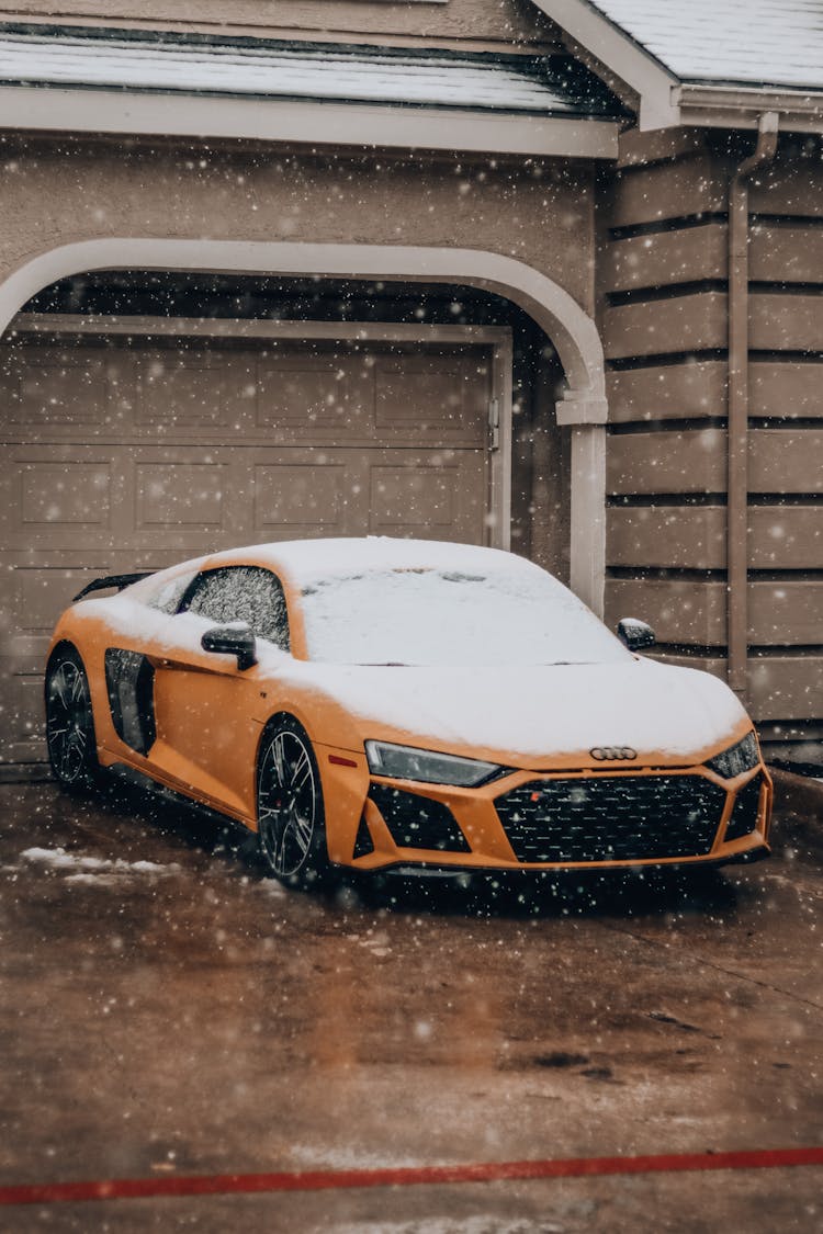 A Sports Car Covered In Snow 