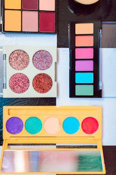 Flat lay of vibrant makeup palettes showcasing diverse colors for artistic inspiration.