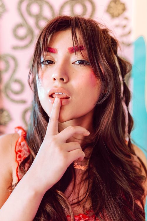 Free Close-up fashion portrait of a woman with vibrant makeup and wavy hair. Stock Photo