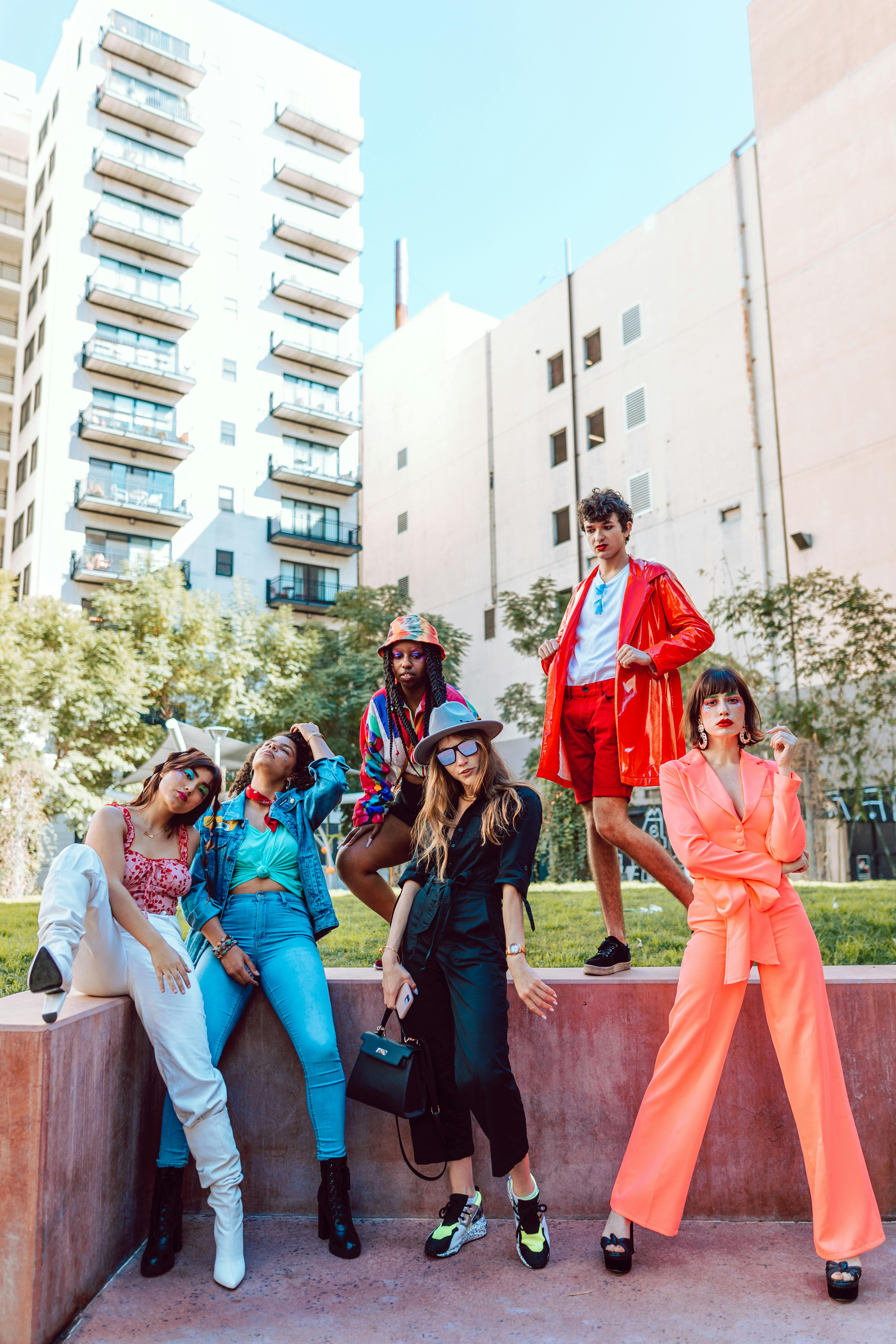 A diverse group of fashionable young adults expressing individuality and style in an urban setting.