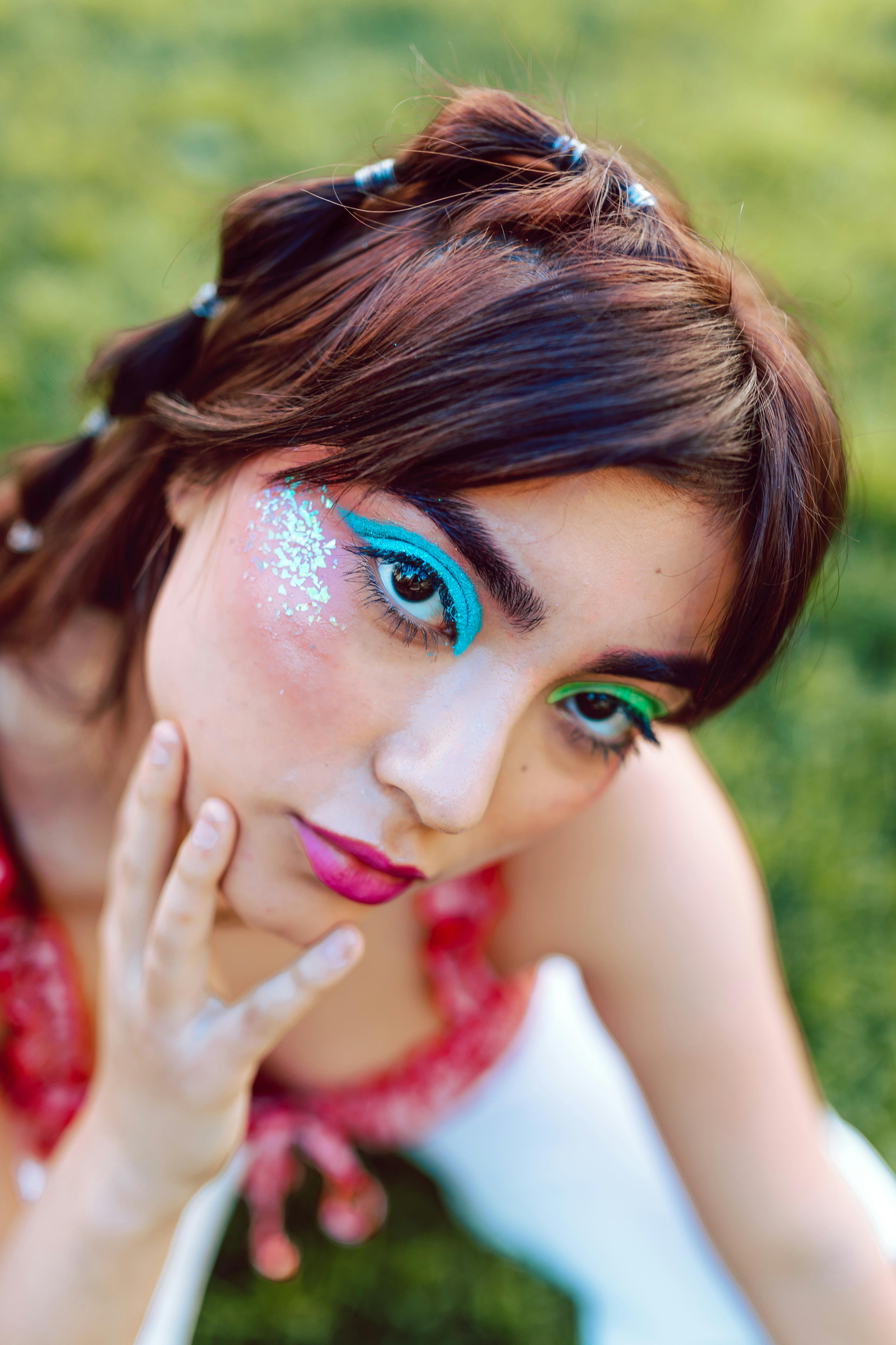 woman posing while wearing colorful eyeshadow