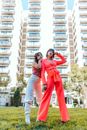 Two Woman Standing on Green Grass
