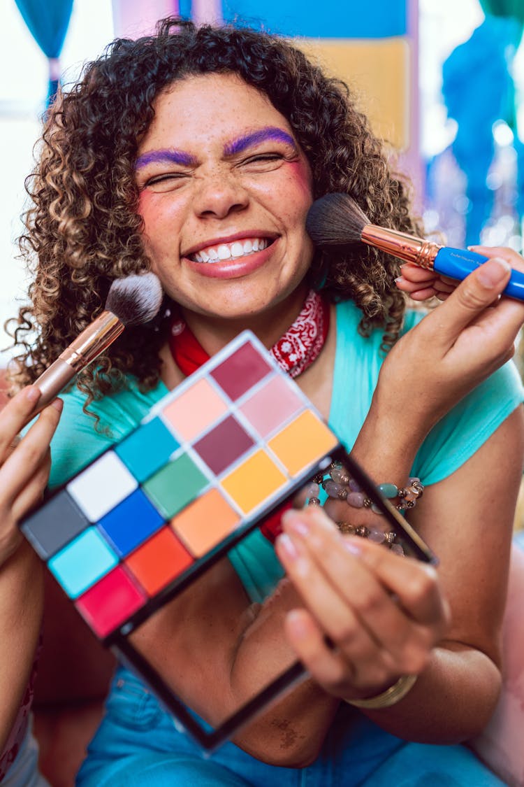 A Woman Applying Makeup On Her Cheek