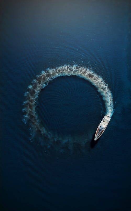 Motor boat making circle on water surface