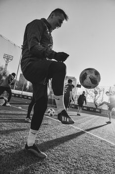 Monochrome action shot of athletes playing soccer outdoors in Moscow.