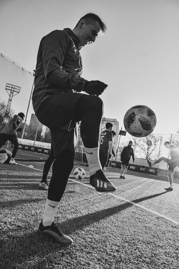 Grayscale Photo Of A Man Playing Soccer