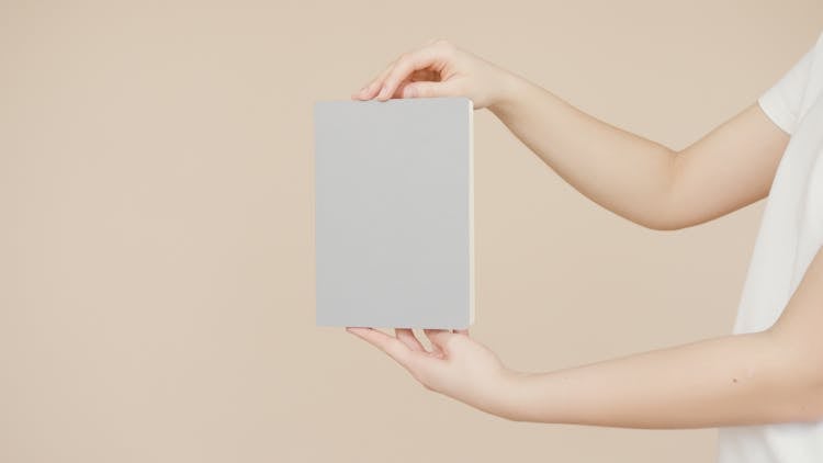 Person Holding A Gray Painted Board