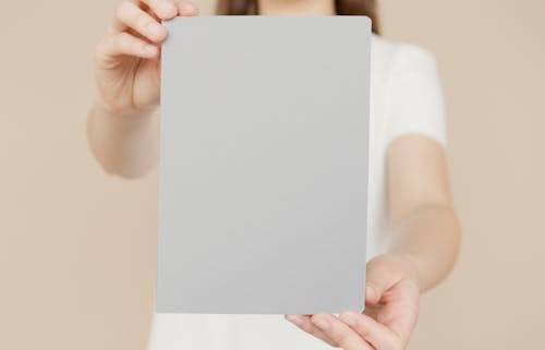 A Person Holding Gray Notepad