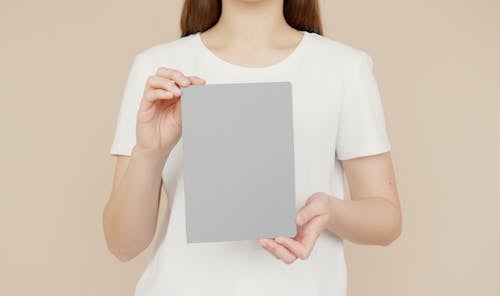 A Person Holding Gray Notepad