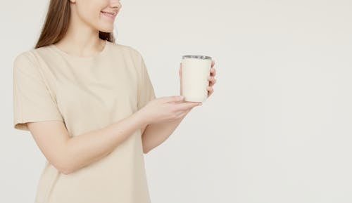 Free A Woman Holding a Cup Stock Photo
