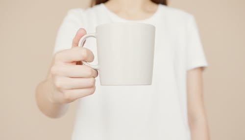 A Person Holding a Cup