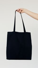 Plain dark canvas tote bag, photo by Artem Podrez on Pexels