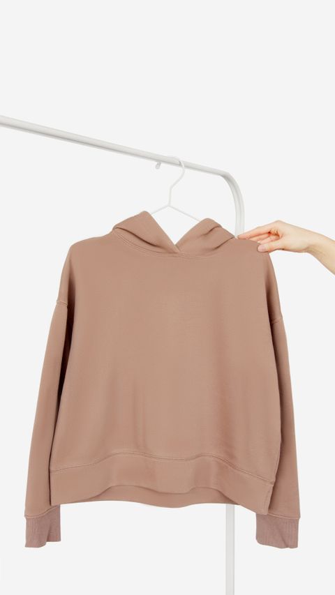 Sand-coloured hoodie on a hanger