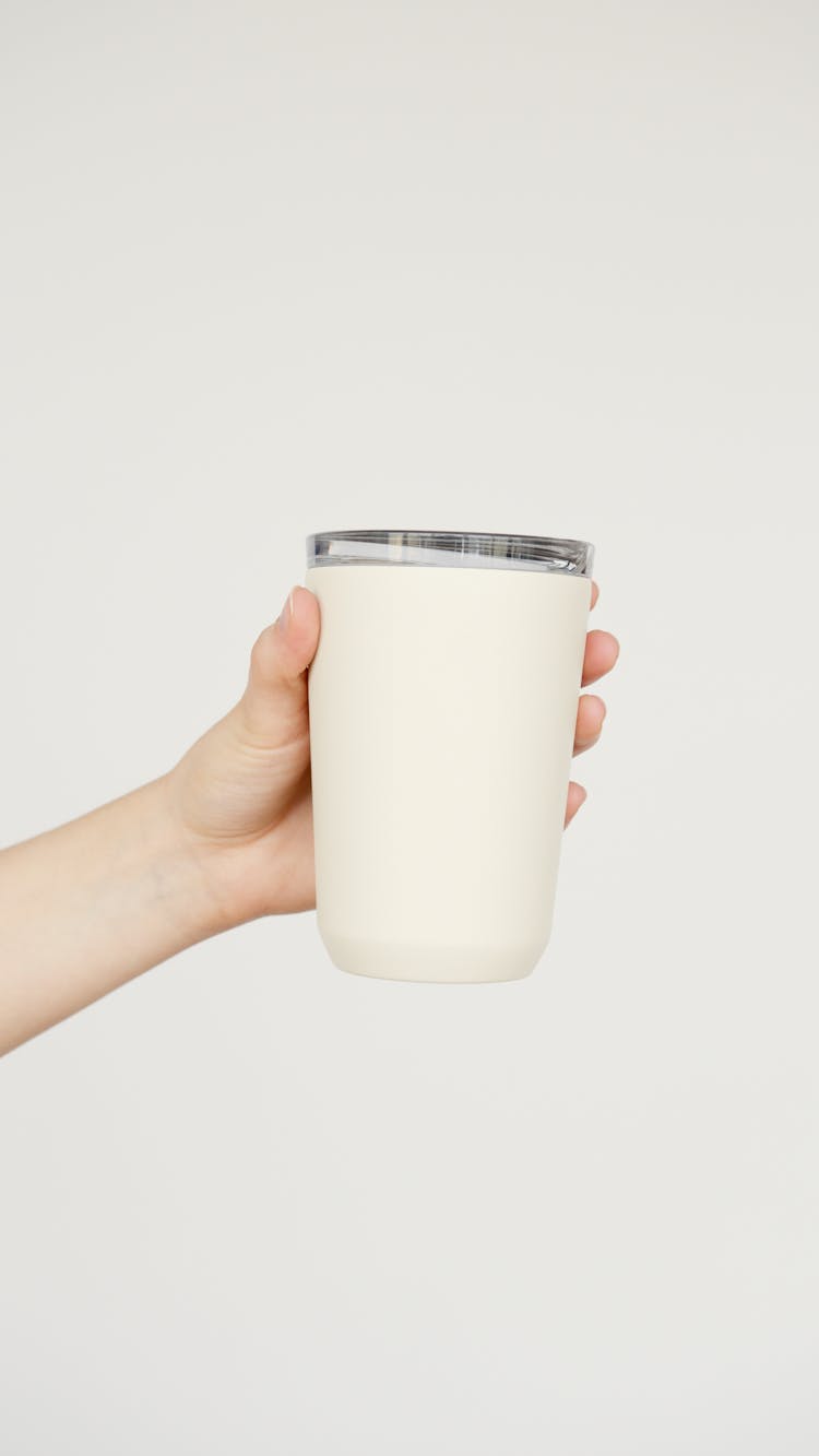 A Person Holding White Cup