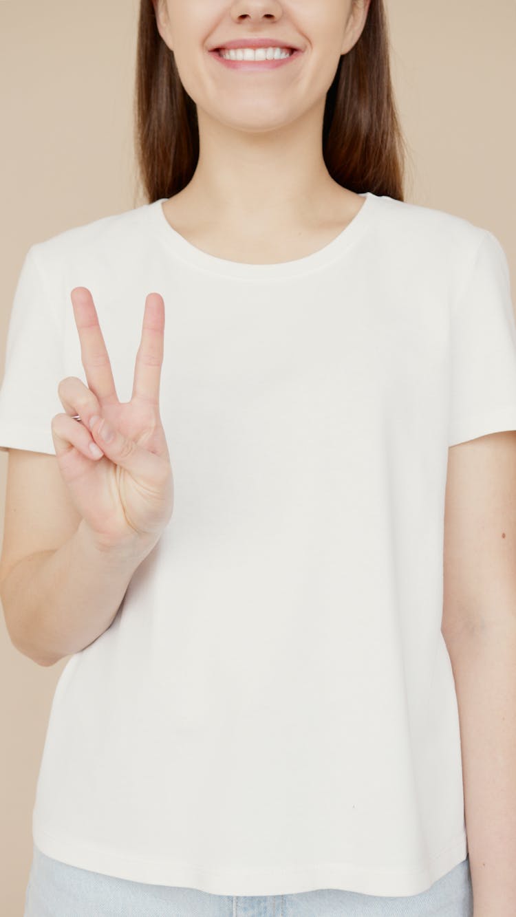 A Woman Making A Peace Sign