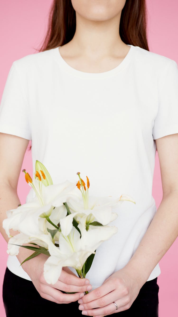 A Person Holding A Bouquet Of White Flowers