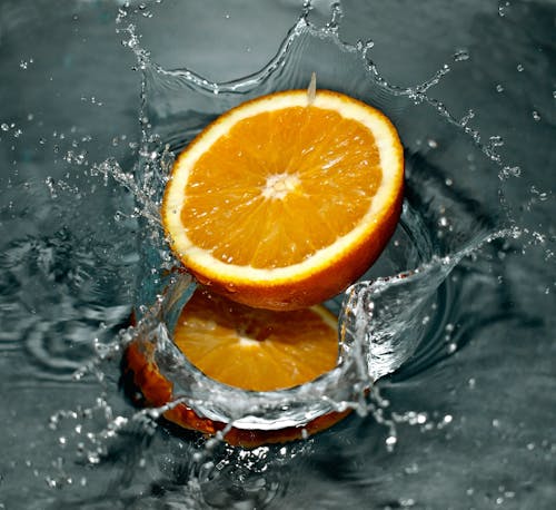 Free Time Lapse Photography of Orange Fruit on Water Stock Photo