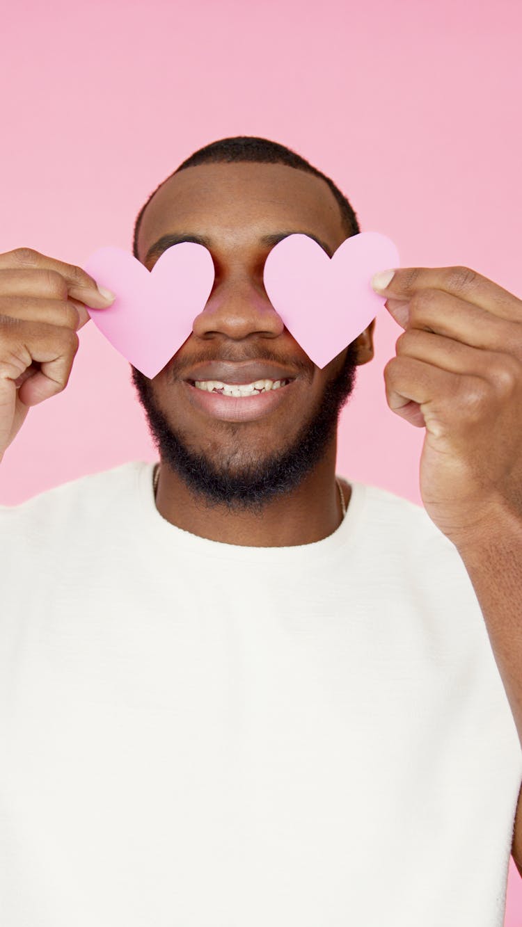 Heart Shaped Papers Covering The Man's Eyes 