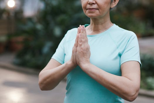 Senior woman in a peaceful yoga pose outdoors, promoting health and mindfulness.