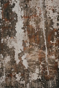 Close-up of a weathered stone wall with aged textures and abstract patterns.