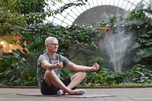 A senior man meditates in a botanical garden, promoting wellness and mindfulness.