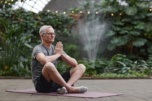 Elderly man practicing yoga meditation indoors surrounded by greenery.