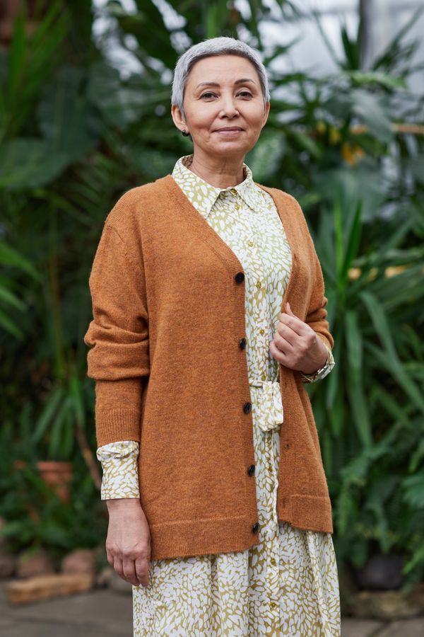Woman wearing a cardigan over a dress casually