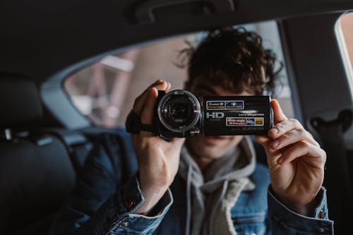 Woman Holding a Black Video Camera · Free Stock Photo
