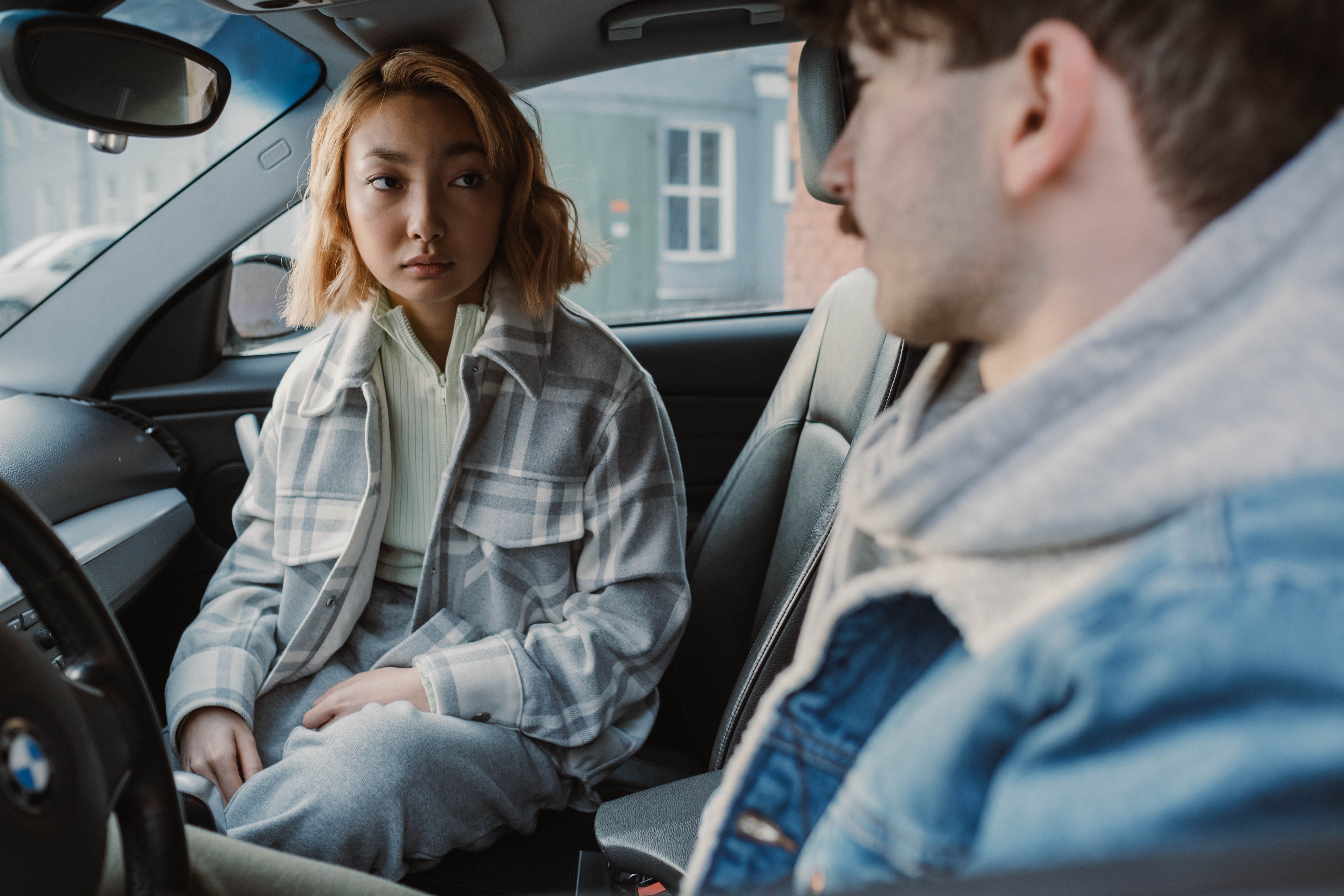 Woman and man in the car looking at each other