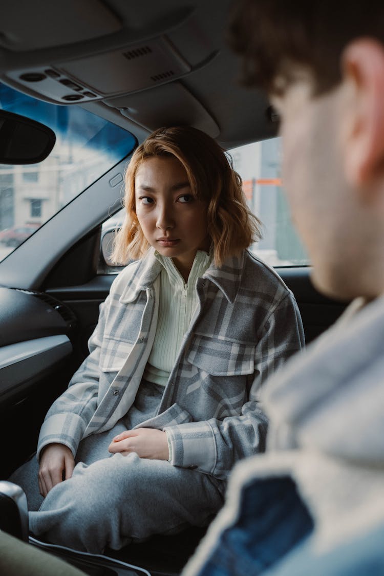 A Woman Sitting In A Car