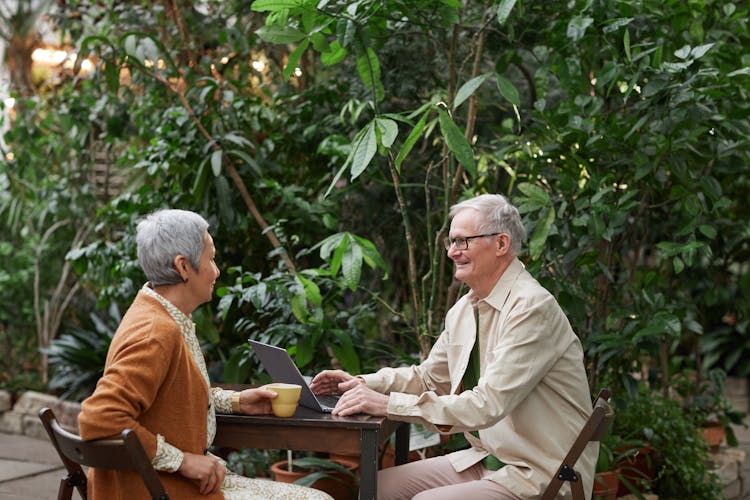 Couple Sitting By The Table While Looking At Each Other