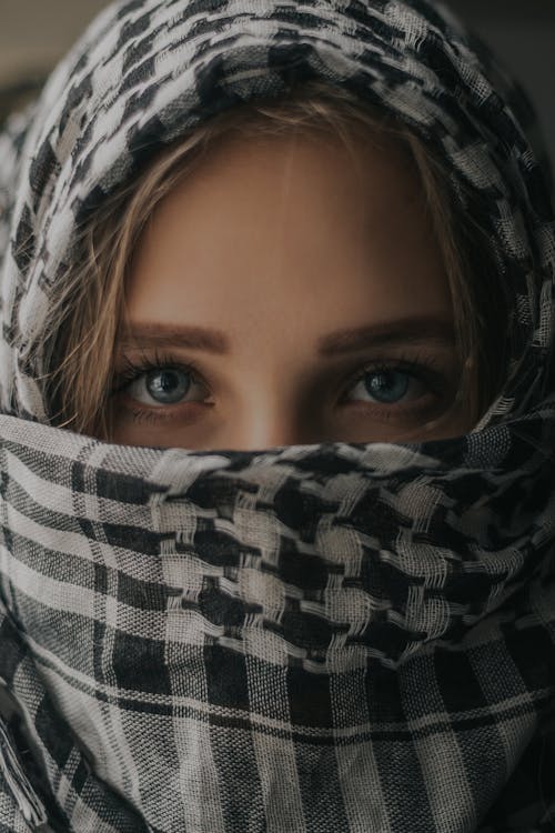 Woman in headscarf covering lower face