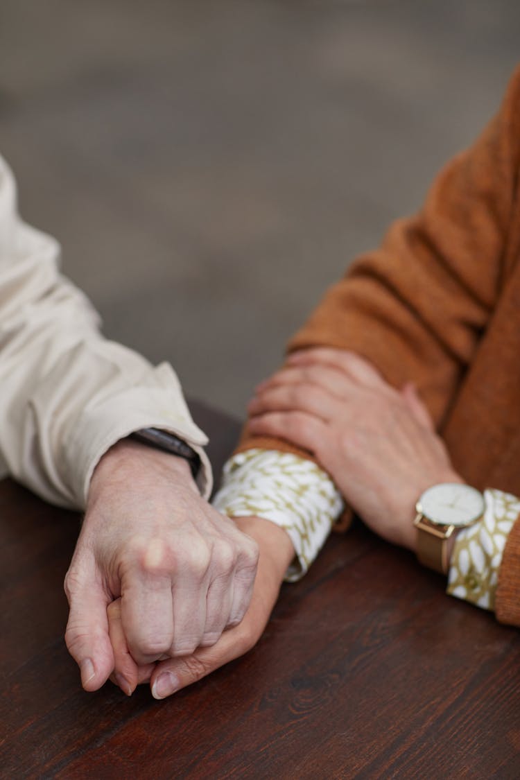 Couple Holding Each Other's Hands