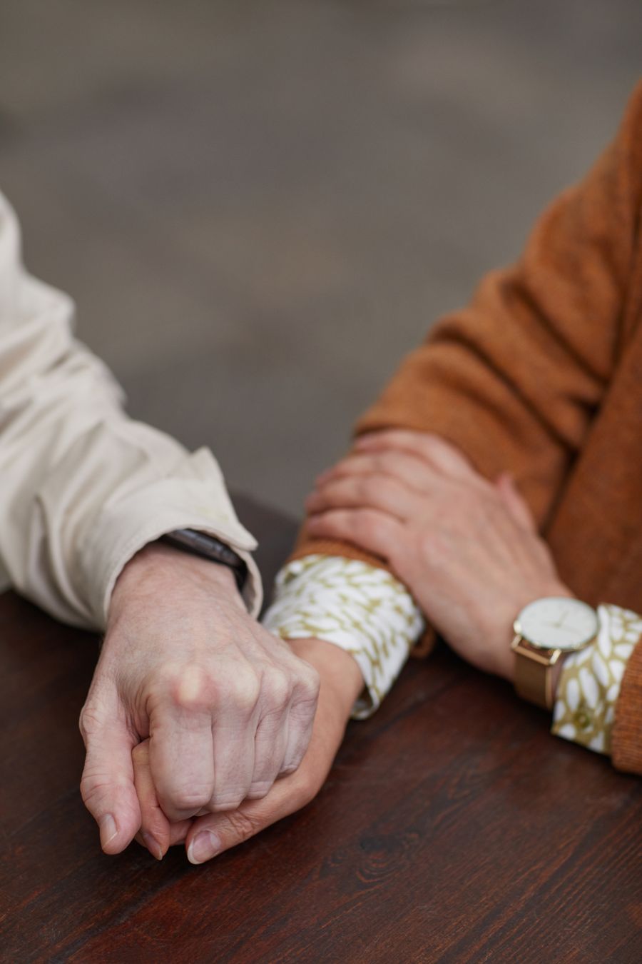 Senior adult couple holding hands with mutual care and trust