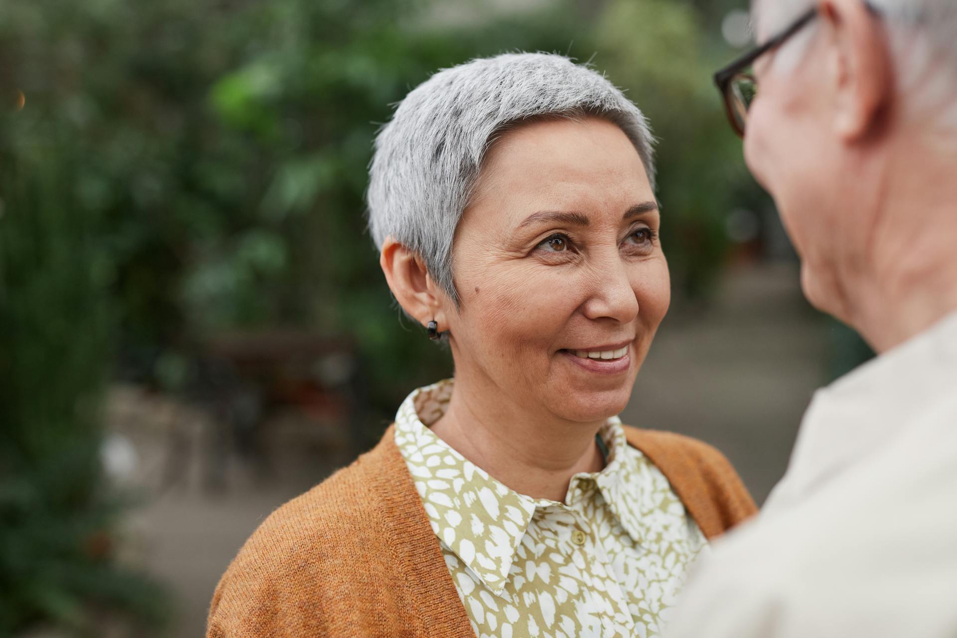 A joyful senior couple sharing a tender moment outdoors, showcasing love and companionship.