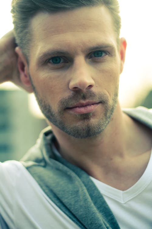 Man in White V-neck Shirt Looking Straight Profile