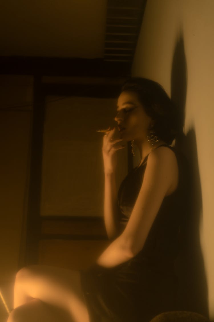 Eccentric Woman In Provocative Black Dress Smoking