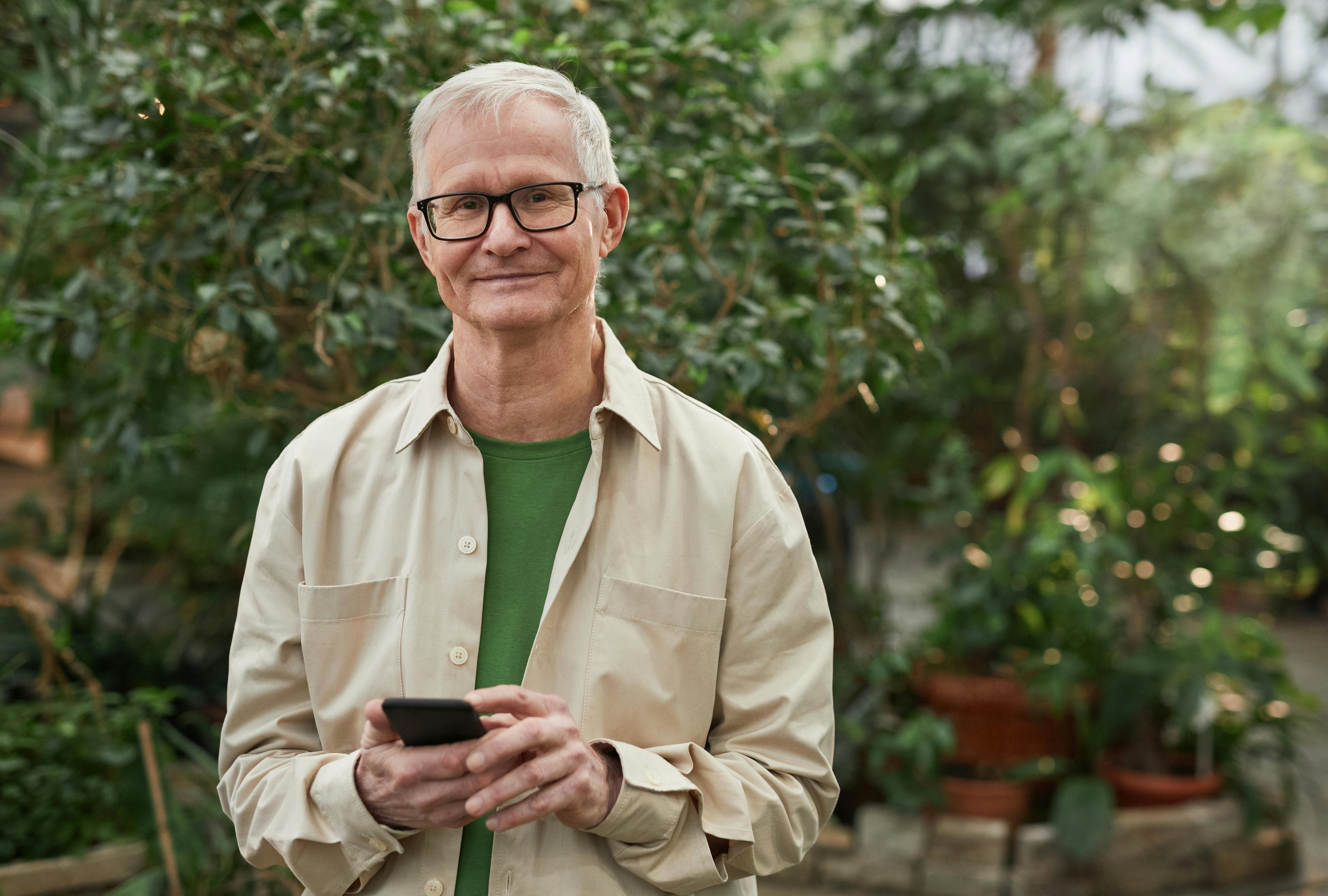 smiling man wearing an eyeglasses while looking at the camera