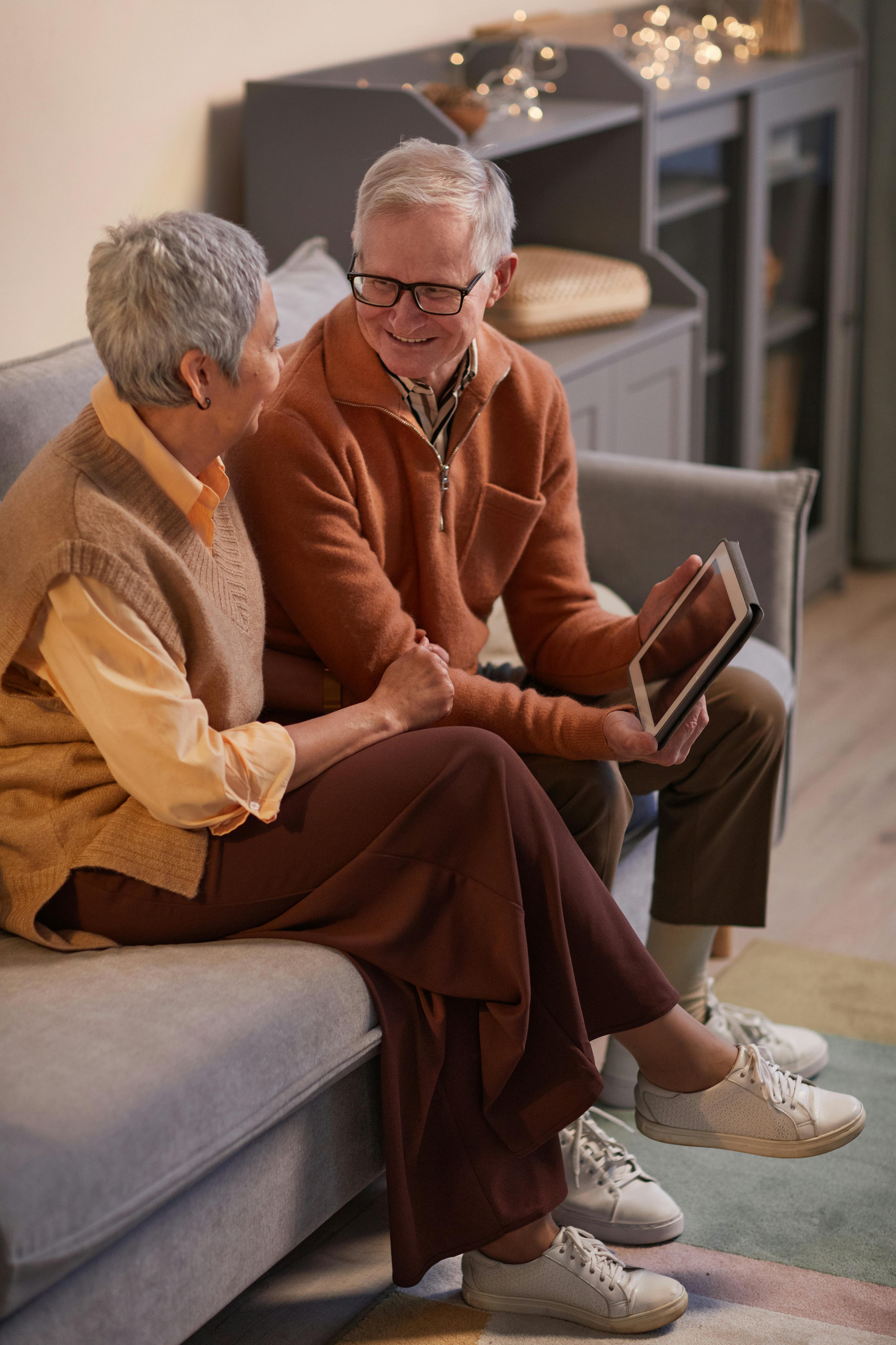 man and woman sitting on sofa while looking at each other