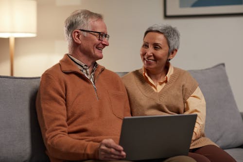 Man and Woman Sitting on Sofa