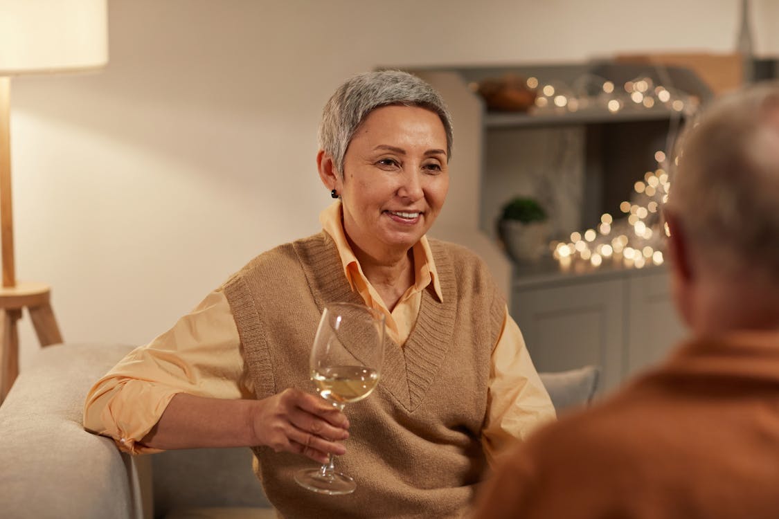 Free Woman Smiling While Holding Wine Glass Stock Photo