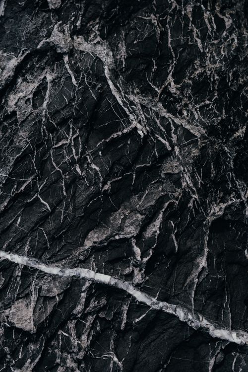 Free Close-up of intricate black marble texture with white veining. Stock Photo
