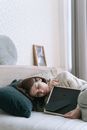 A Woman Lying on the Bed while Holding a Picture Frame