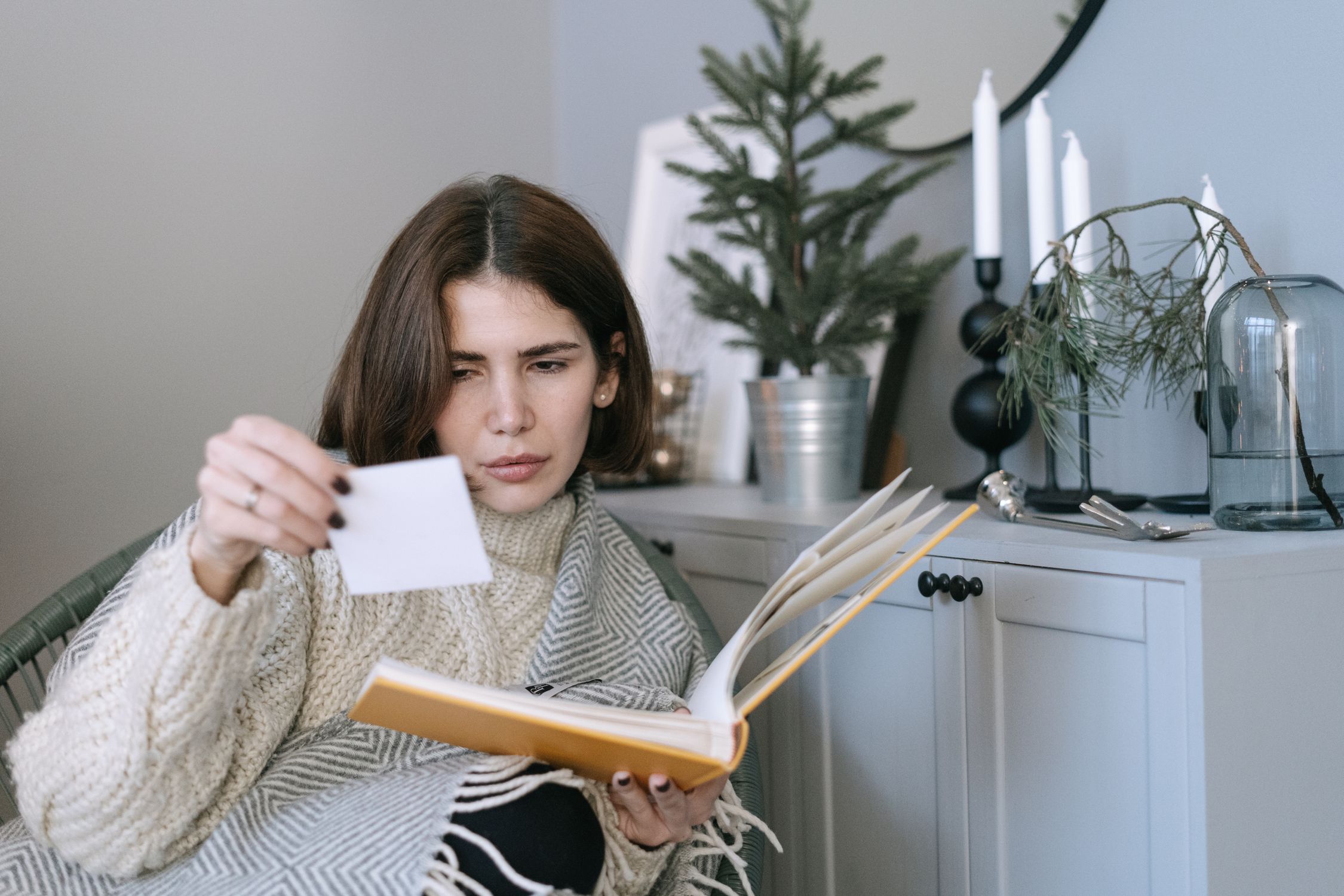Woman reviewing photos and documents before confirming accommodation booking Woman reviewing photos and documents before confirming accommodation booking