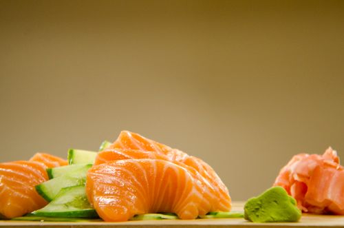 Free Close-up of fresh salmon sashimi with cucumber, wasabi, and ginger. Stock Photo