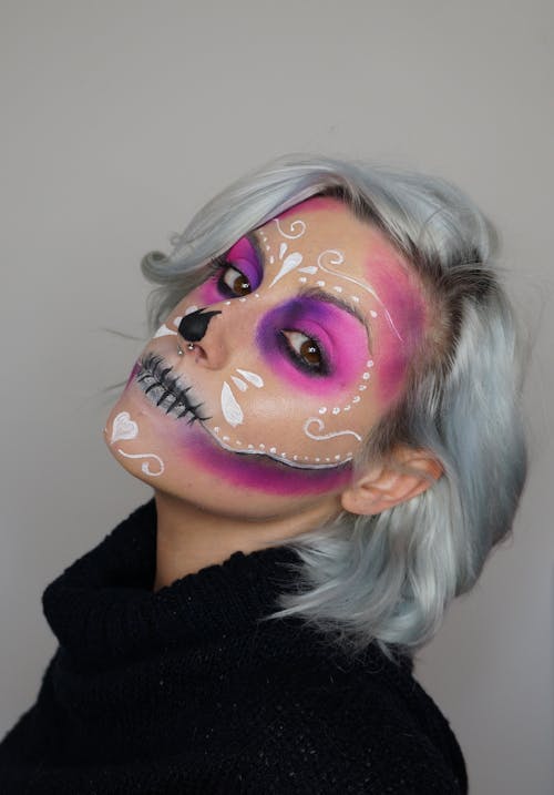 Woman in Black Sweater With Pink Face Painting