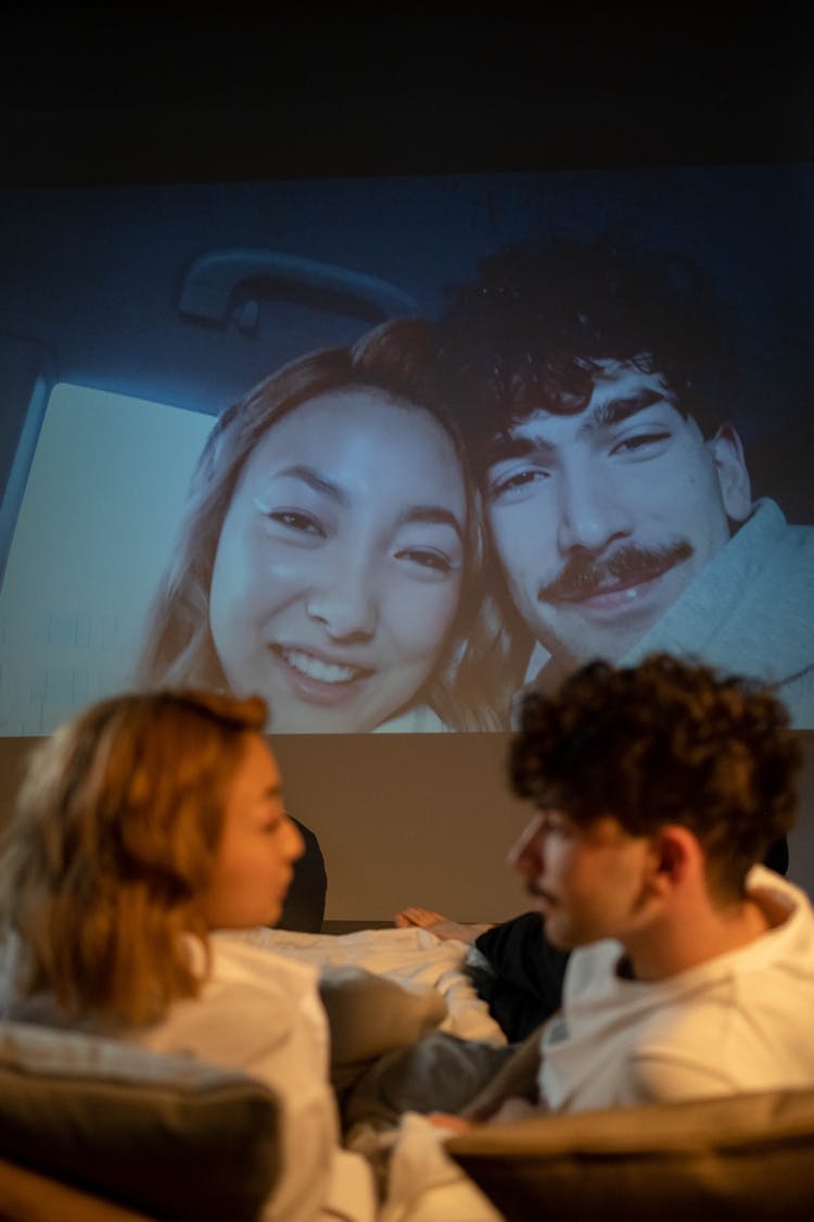 A Couple Watching At The Projector Screen