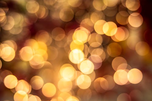 Full frame abstract background of bright glowing lights and specks of bright yellow illumination