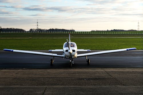 Photograph of a Silver and Blue Airplane on a Runway