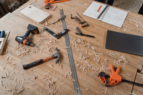 Workbench with woodworking tools and project sketches